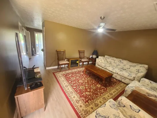 a living room with couch and a chandelier