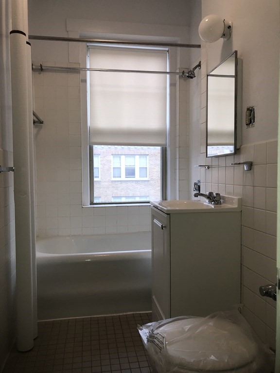 11 Perkins Square, Unit 11 Boston, MA 02130 - Photo 8 of 12 a bathroom with a toilet a sink and shower