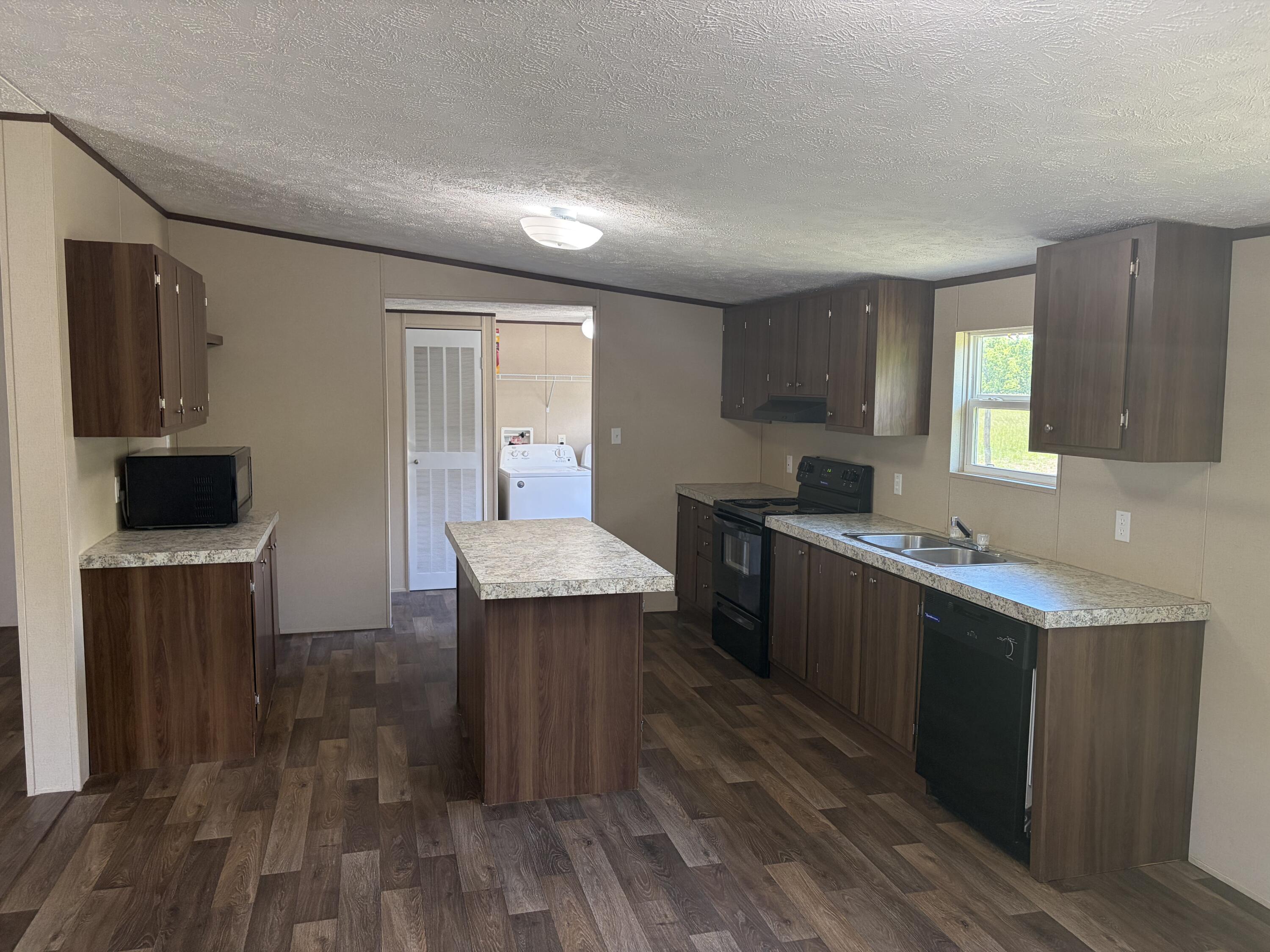 1644 Gap Road Chatham, VA 24531 - Photo 5 of 15 a kitchen with granite countertop a sink and a stove top oven