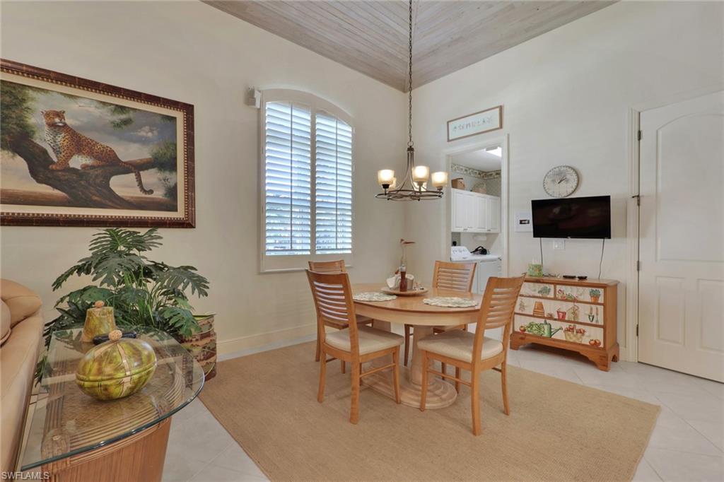 435 Terracina Way Naples, FL 34119 - Photo 13 of 50 a view of a dining room with furniture and a chandelier