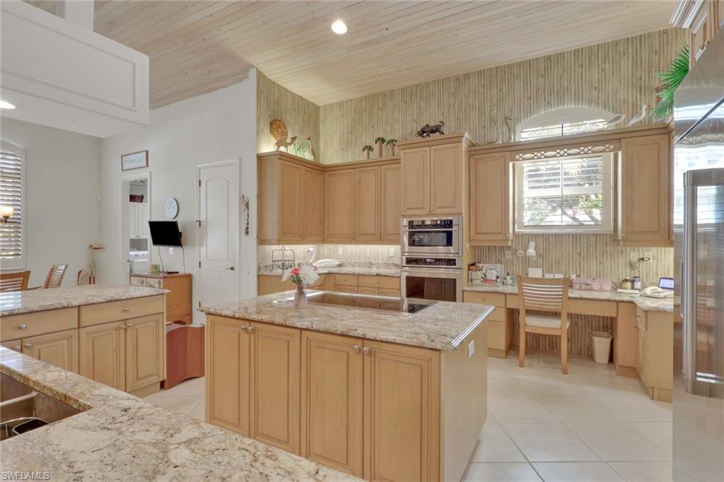 435 Terracina Way Naples, FL 34119 - Photo 19 of 50 a large kitchen with a counter top space a sink stainless steel appliances and cabinets