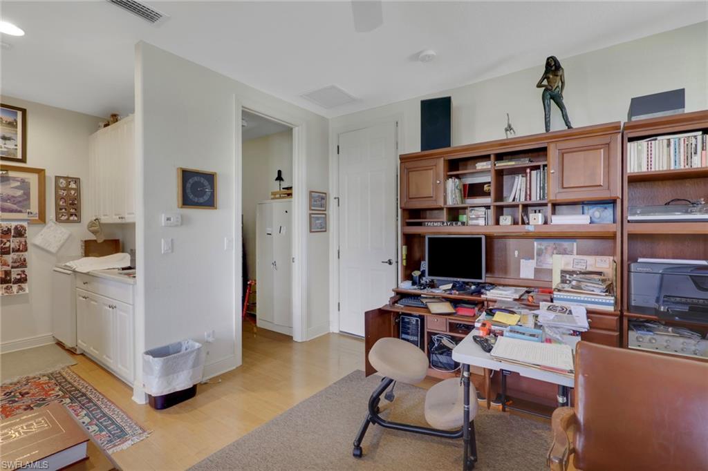 435 Terracina Way Naples, FL 34119 - Photo 25 of 50 a workspace with furniture and a bookshelf