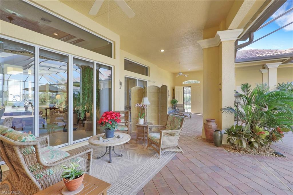 435 Terracina Way Naples, FL 34119 - Photo 33 of 50 a living room filled with furniture and a potted plant