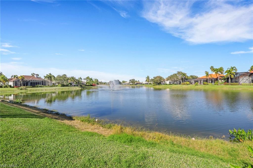 435 Terracina Way Naples, FL 34119 - Photo 35 of 50 a view of a lake with houses in the back