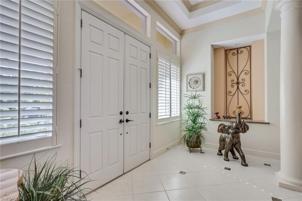 435 Terracina Way Naples, FL 34119 - Photo 4 of 50 a view of a entryway door with a chair