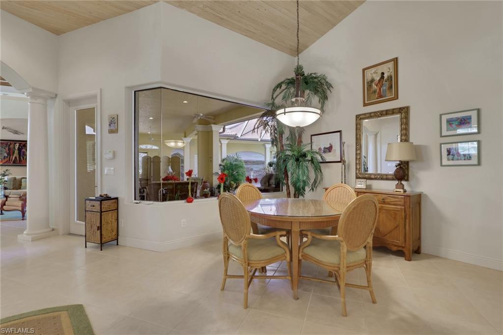 435 Terracina Way Naples, FL 34119 - Photo 8 of 50 a dining room with furniture and a chandelier