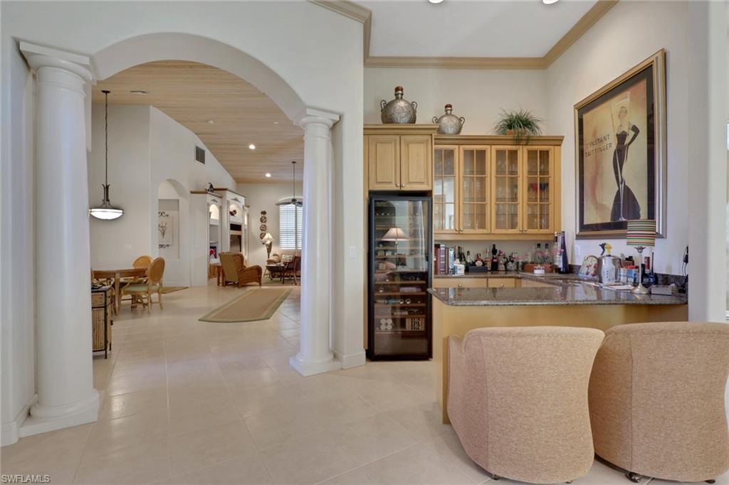435 Terracina Way Naples, FL 34119 - Photo 9 of 50 a view of a kitchen and living room