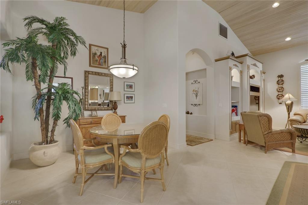 435 Terracina Way Naples, FL 34119 - Photo 10 of 50 a dining room with furniture and a chandelier