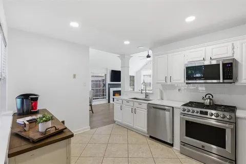 a kitchen with stainless steel appliances a stove a sink and a microwave
