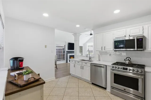a kitchen with stainless steel appliances a stove a sink and a microwave