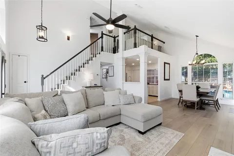 a living room with furniture and a chandelier