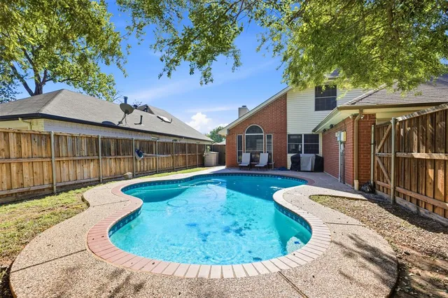 a view of a house with swimming pool in front of it