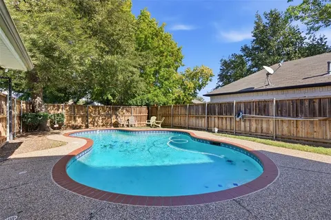 a view of a swimming pool with a patio