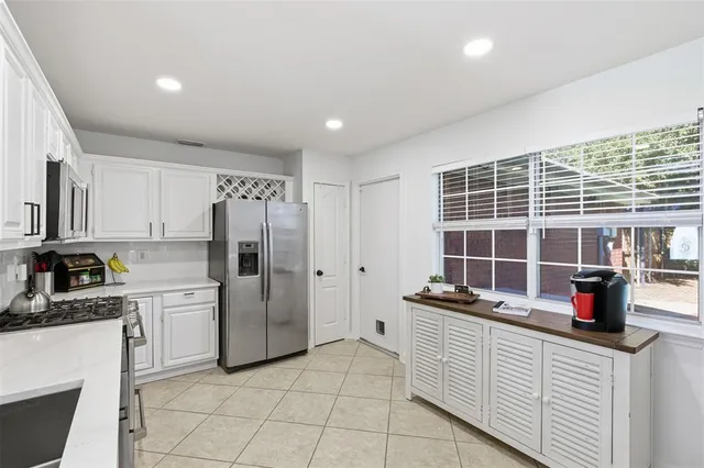 a kitchen with refrigerator and cabinets