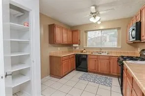 a kitchen with stainless steel appliances granite countertop a stove sink and cabinets