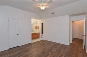 a view of a room with wooden floor and a ceiling fan