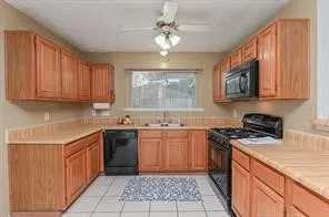a kitchen with stainless steel appliances granite countertop a sink stove top oven and cabinets