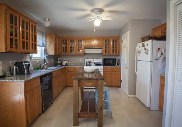 a kitchen with a refrigerator a sink and dishwasher