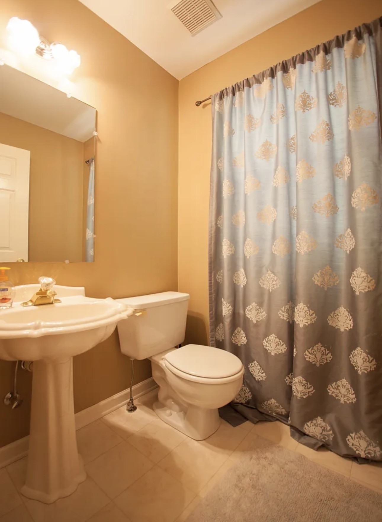 108 Granger View Court Franklin, TN 37064 - Photo 6 of 7 a bathroom with a sink a toilet and shower curtain