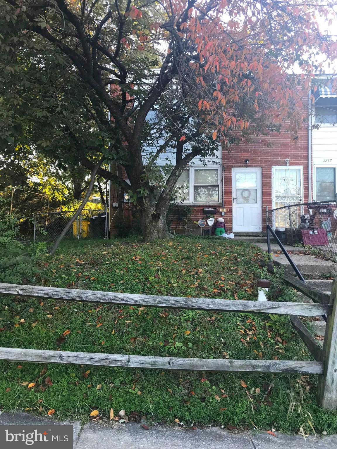 a view of a house with a big yard and large trees