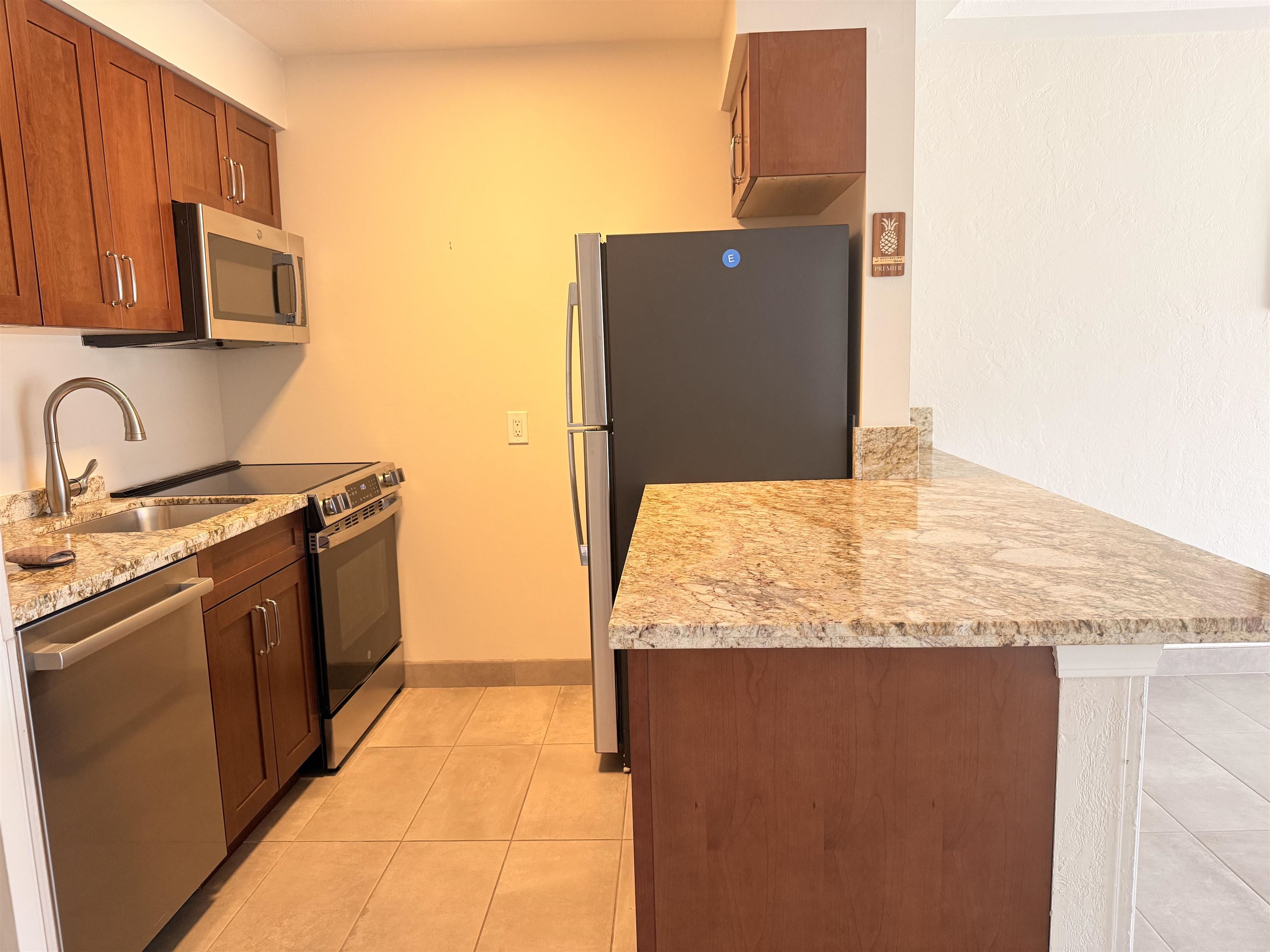 a kitchen with stainless steel appliances granite countertop a sink and a stove