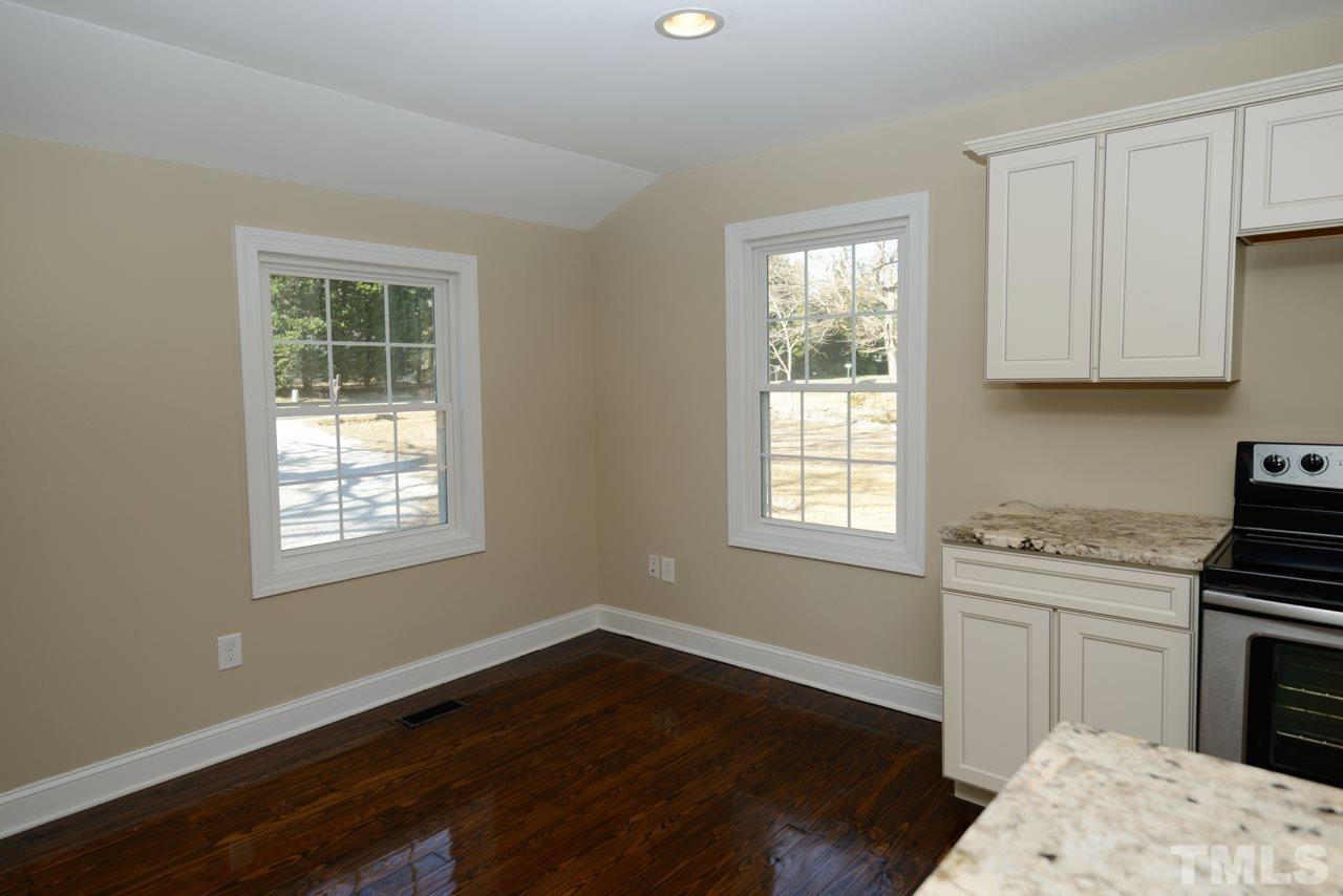 8300 Pinecrest Road Raleigh, NC 27613 - Photo 2 of 12 a kitchen with a sink wooden floor and a window