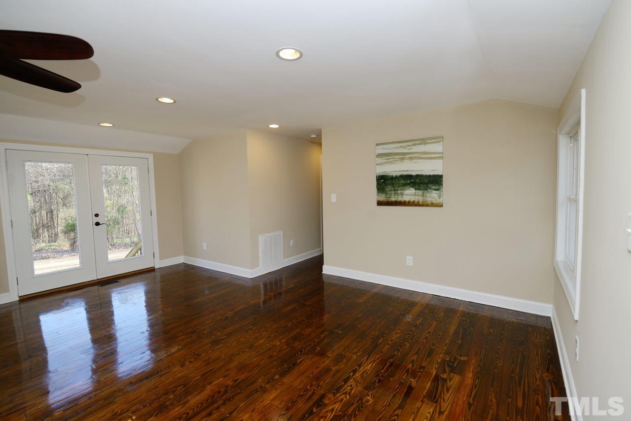 8300 Pinecrest Road Raleigh, NC 27613 - Photo 3 of 12 an empty room with wooden floor and windows