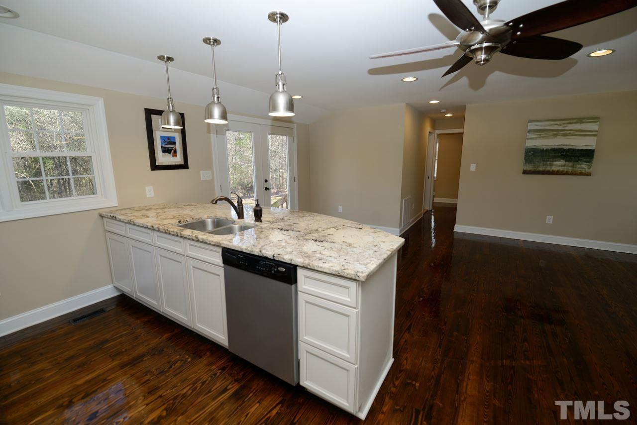 8300 Pinecrest Road Raleigh, NC 27613 - Photo 4 of 12 a kitchen with a sink cabinets and wooden floor