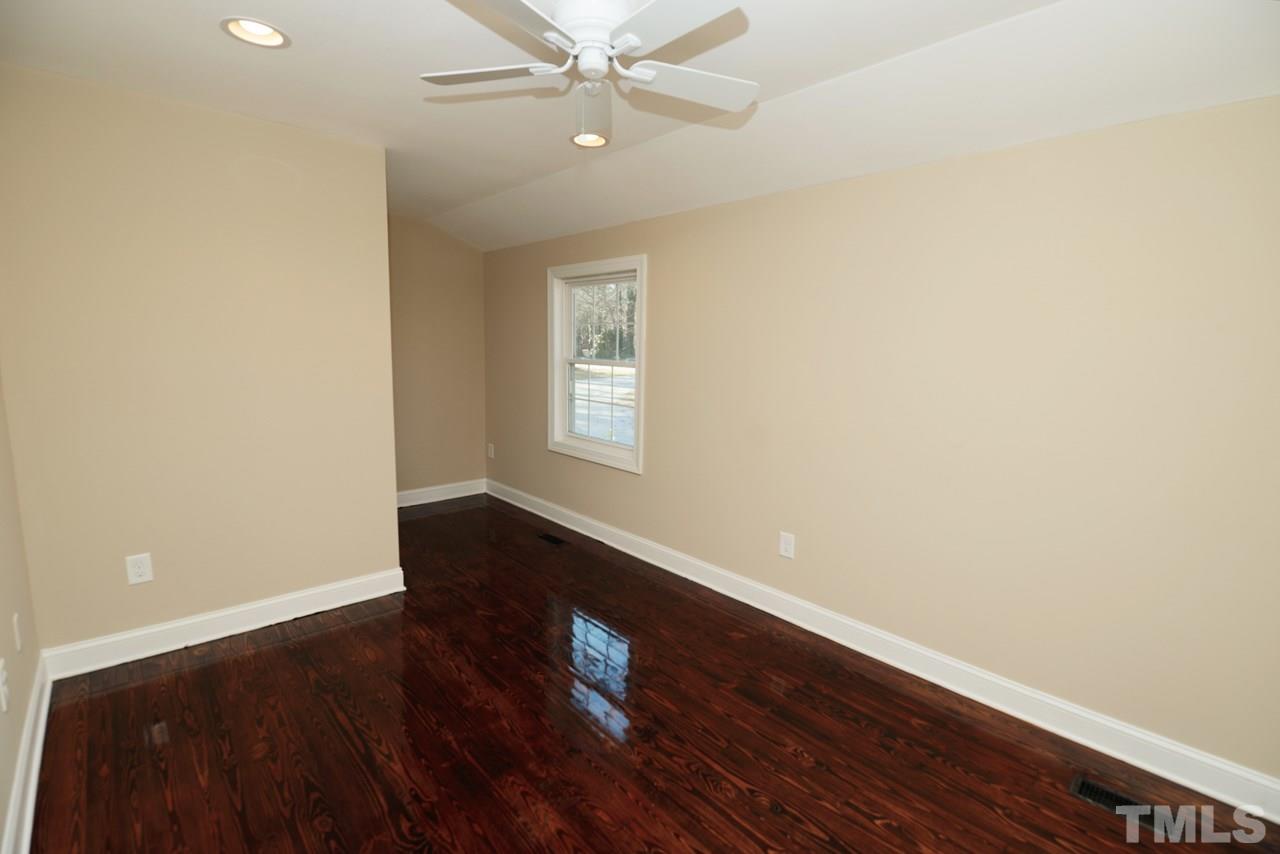 8300 Pinecrest Road Raleigh, NC 27613 - Photo 5 of 12 wooden floor in an empty room with a window