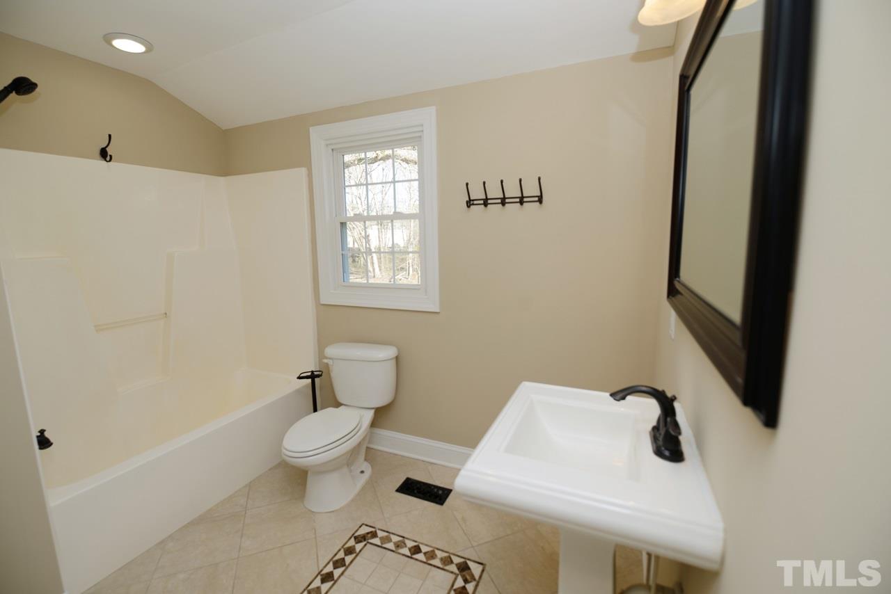 8300 Pinecrest Road Raleigh, NC 27613 - Photo 7 of 12 a bathroom with a sink and toilet