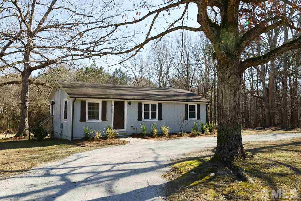 8300 Pinecrest Road Raleigh, NC 27613 - Photo 10 of 12 a front view of house with yard and trees around