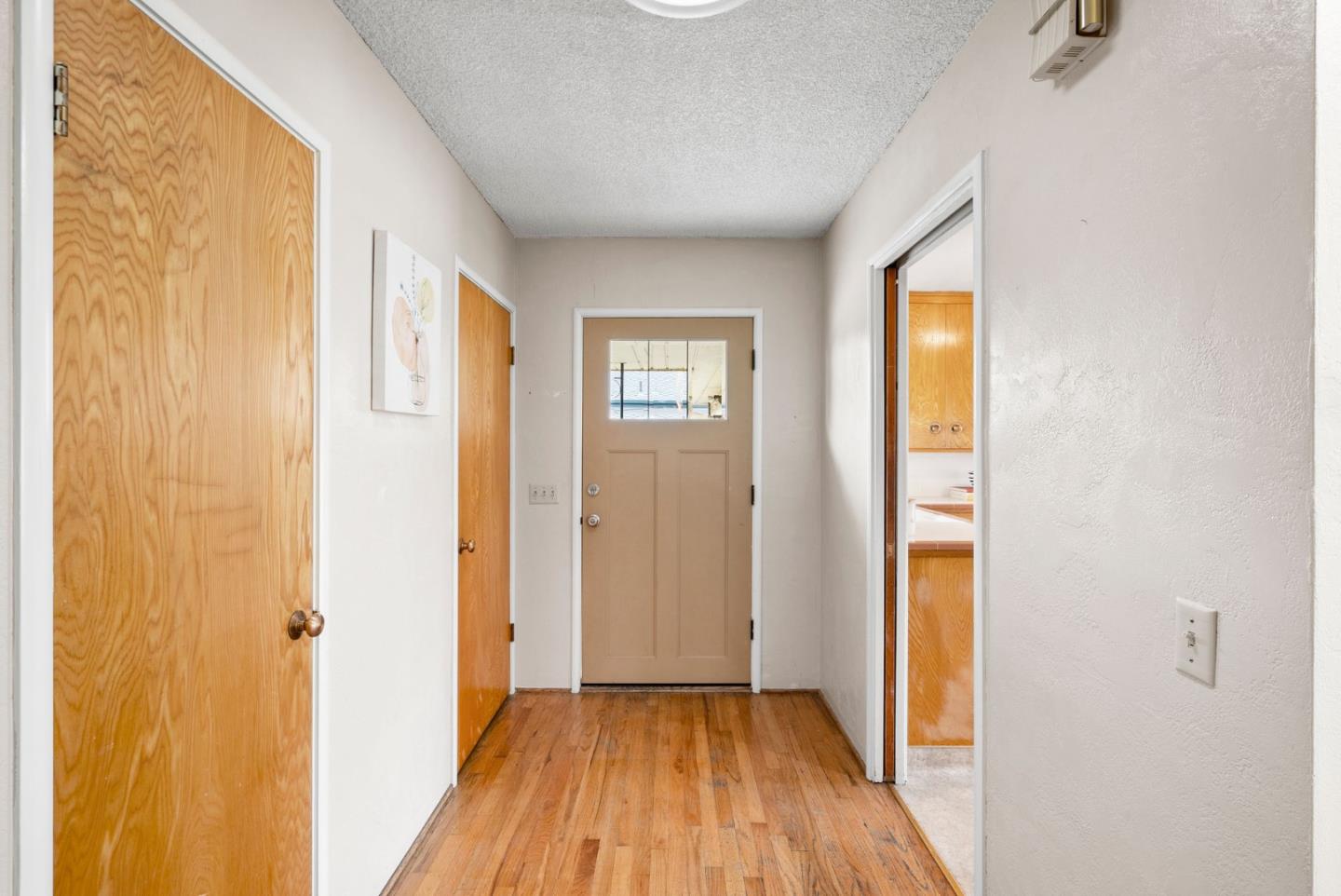345 Green Valley Road Watsonville, CA 95076 - Photo 21 of 44 a view of a hallway with wooden floor and a bathroom