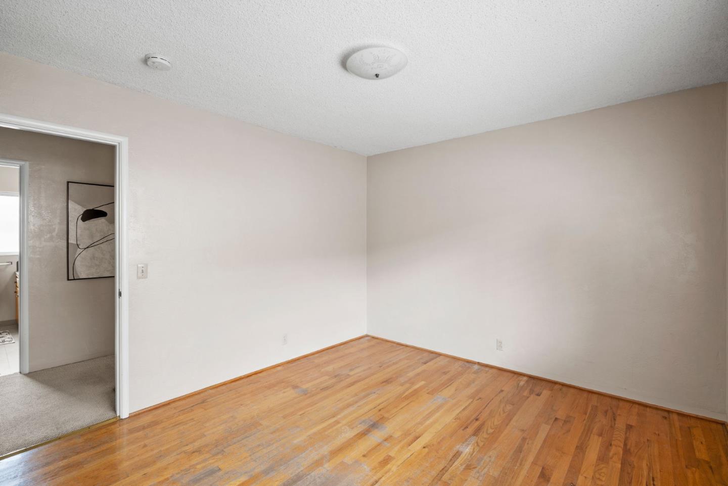 345 Green Valley Road Watsonville, CA 95076 - Photo 24 of 44 a view of empty room with wooden floor and cabinet