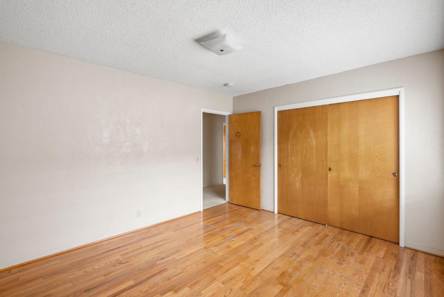 345 Green Valley Road Watsonville, CA 95076 - Photo 26 of 44 a view of an empty room with wooden floor and a window