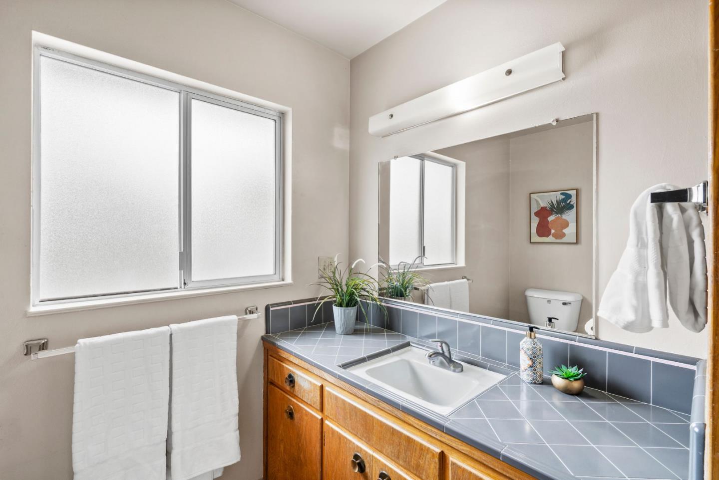 345 Green Valley Road Watsonville, CA 95076 - Photo 36 of 44 a bathroom with a sink and a mirror