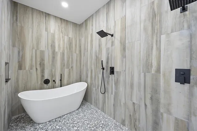a white bath tub sitting next to a shower curtain