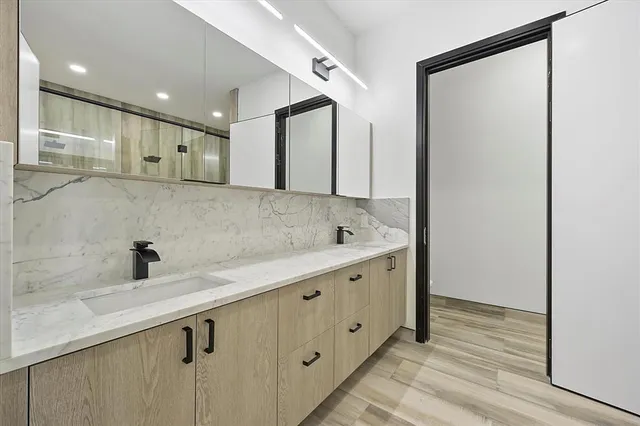 a bathroom with a double vanity sink and mirror