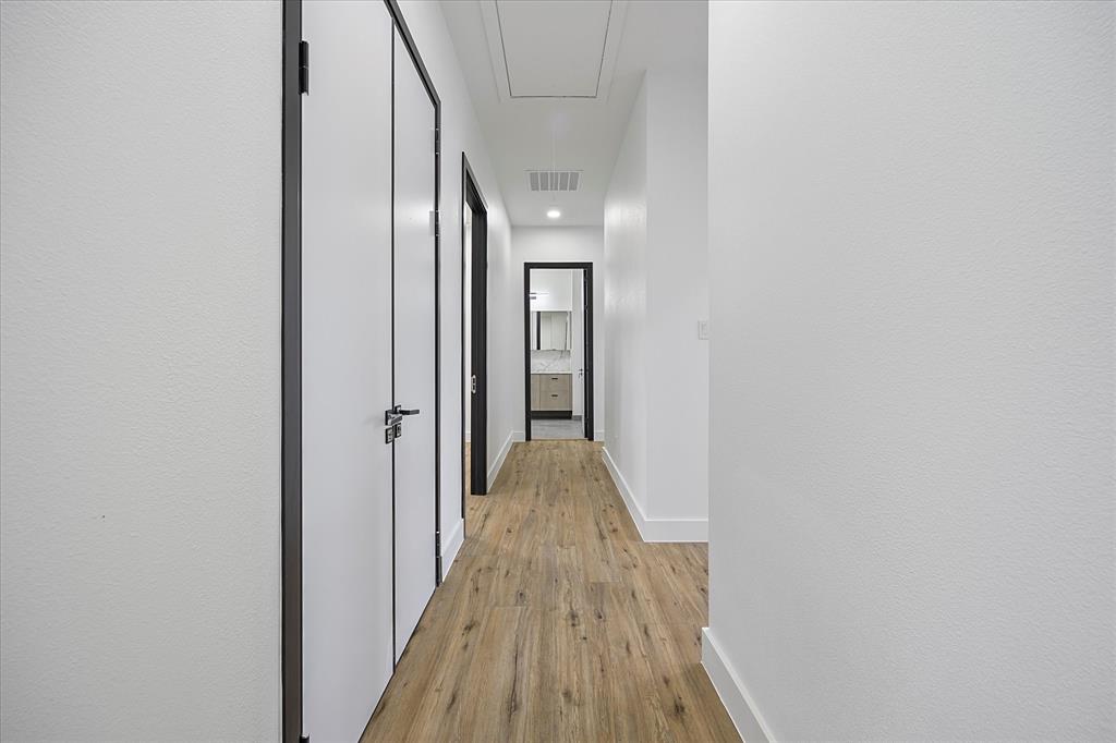 2811 Rodeo Drive Quinlan, TX 75474 - Photo 19 of 35 Hall with attic access, light wood-style floors, and recessed lighting