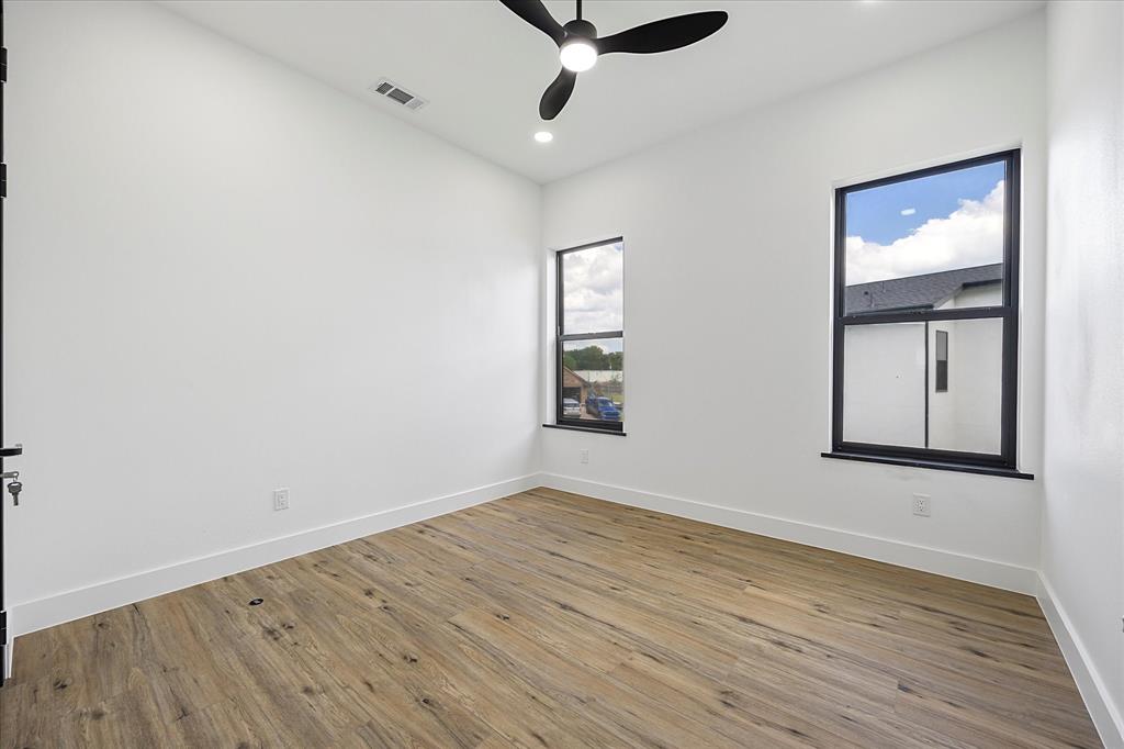 2811 Rodeo Drive Quinlan, TX 75474 - Photo 22 of 35 Spare room featuring ceiling fan, wood finished floors, and recessed lighting