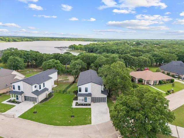 an aerial view of a house with garden space and ocean view