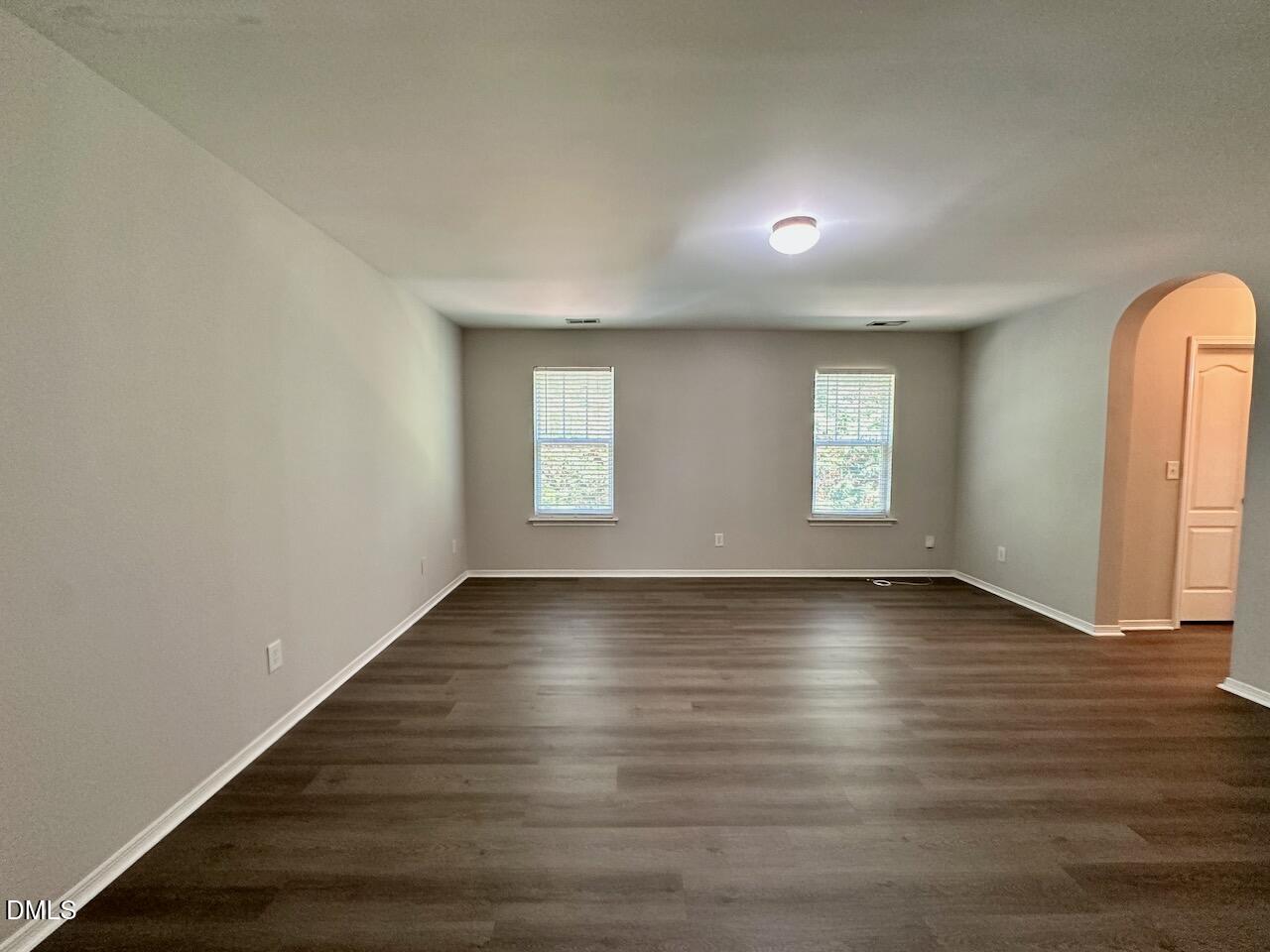 8208 Stone Cellar Drive Raleigh, NC 27613 - Photo 19 of 34 an empty room with wooden floor and windows