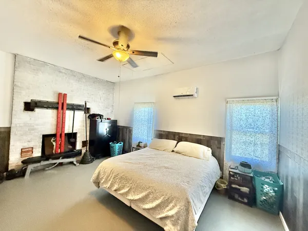 a bedroom with a bed and a ceiling fan