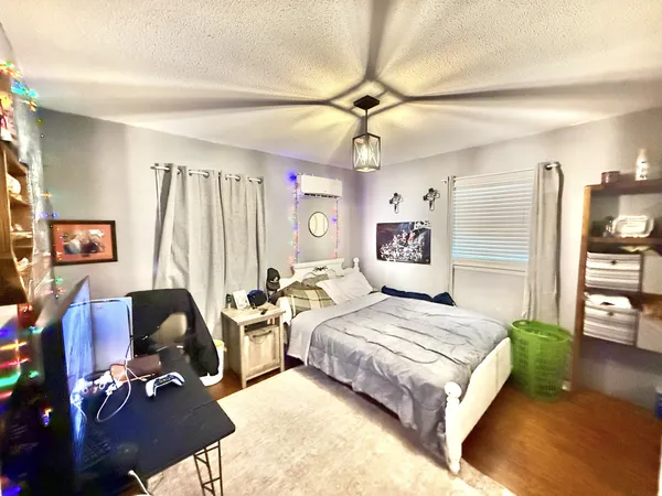 a bedroom with a bed couch and a window
