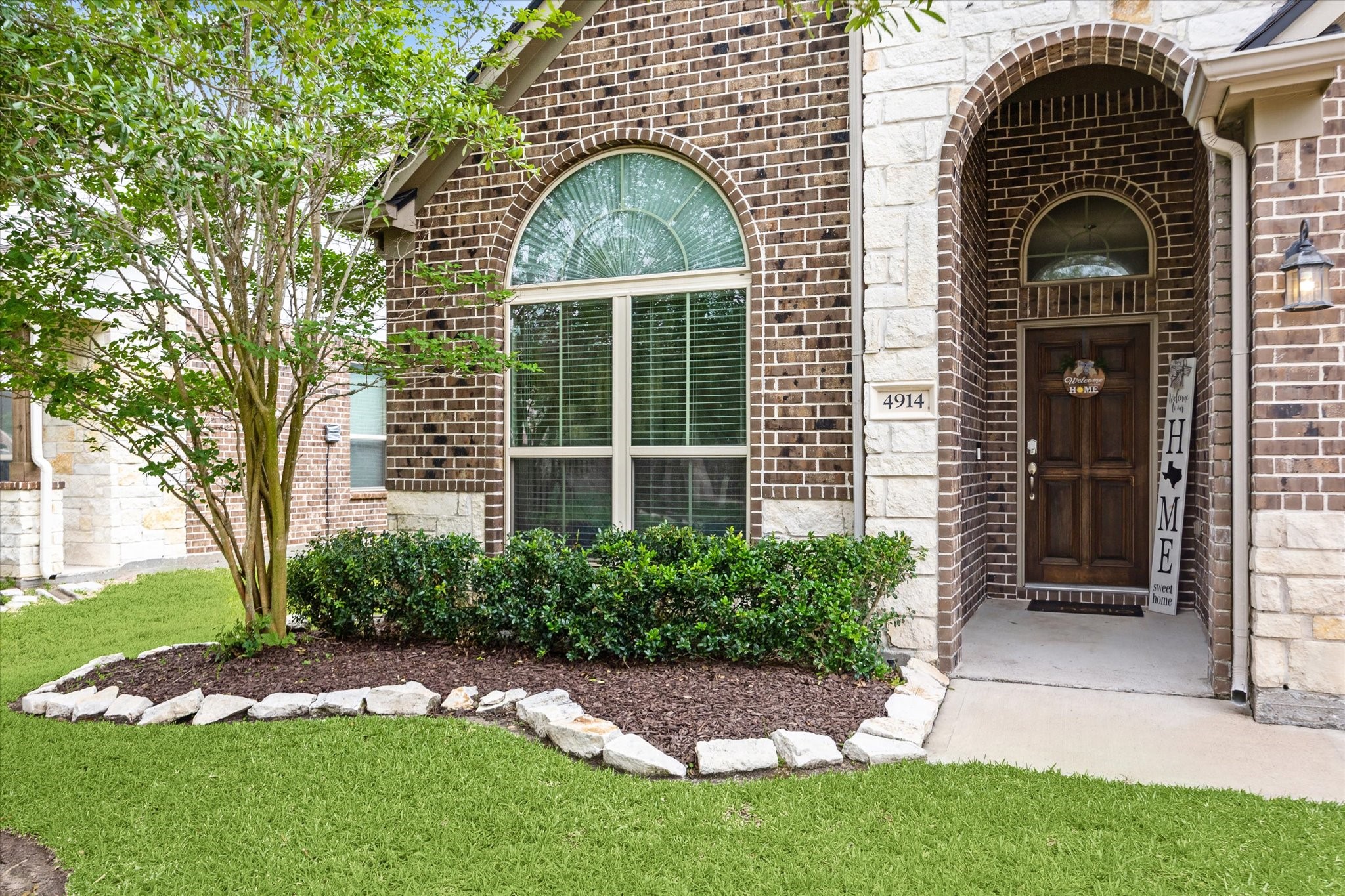 4914 Mountain Maple Trail Rosenberg, TX 77471 - Photo 3 of 23 Check out this beautiful elevation with brick and stone combination! The stones around the flowerbeds make the perfect pop and decor!