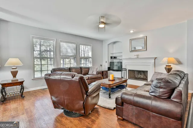 a living room with furniture and a wooden floor