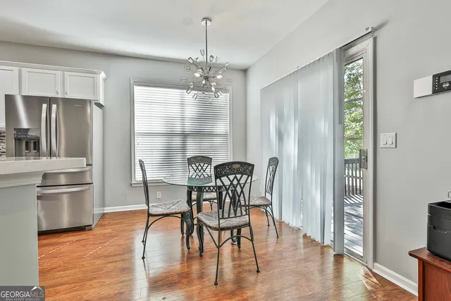 a kitchen with white cabinets stainless steel appliances and a refrigerator
