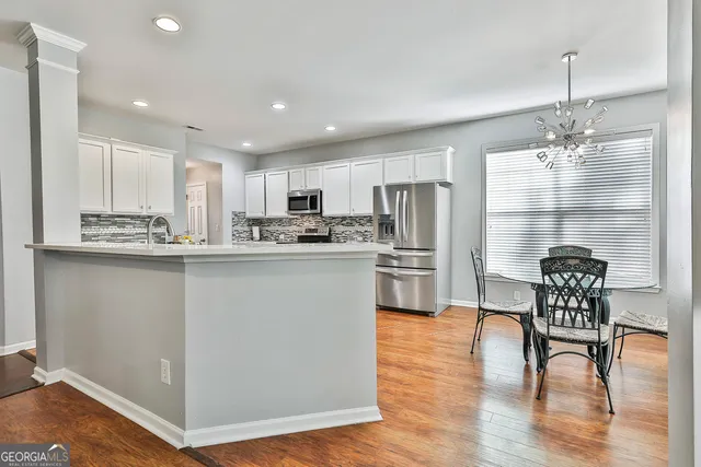 a kitchen with stainless steel appliances a stove a sink a oven with a refrigerator