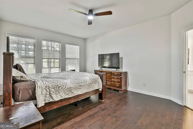 a view of a hallway with wooden floor and workspace