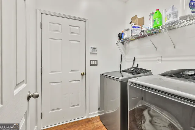a bedroom with a bed and a flat tv screen on dresser