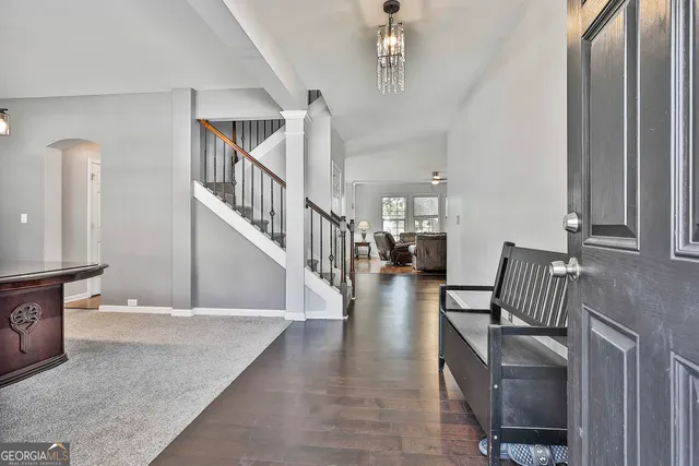 a living room with furniture a fireplace and a window